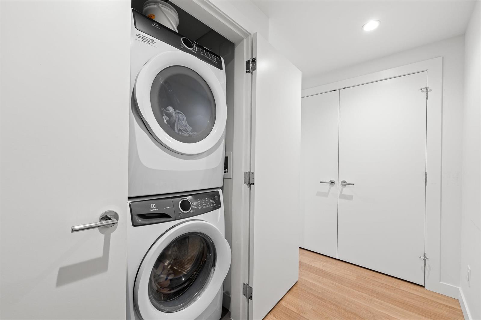 The laundry, a washer and dryer stacked in the hall closet.