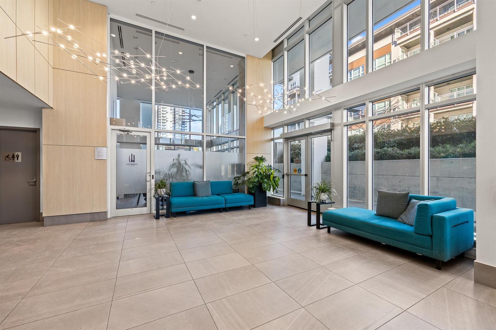 The lobby, seating under a double-height wall of glass.