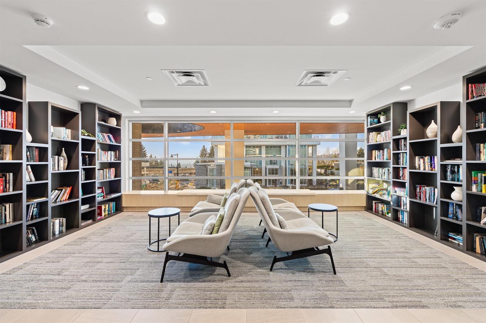 The library, armchairs between full-height shelves.