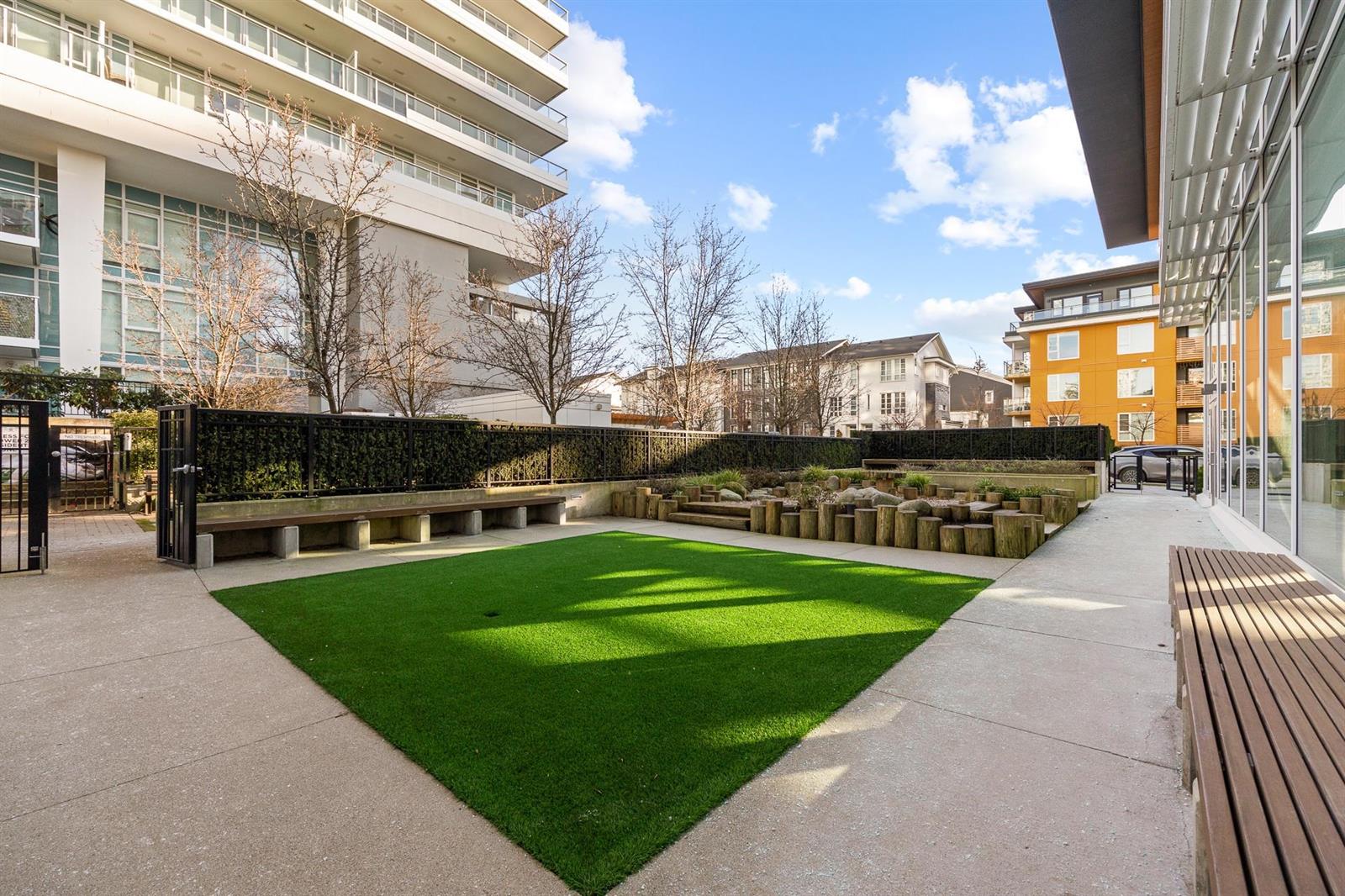 The courtyard, lawn and benches laid out between the towers.