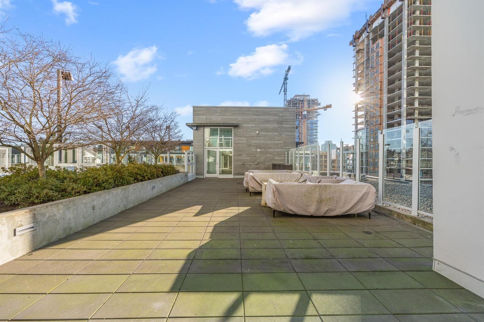The outdoor terrace, a daybed on the paving with the tower behind.