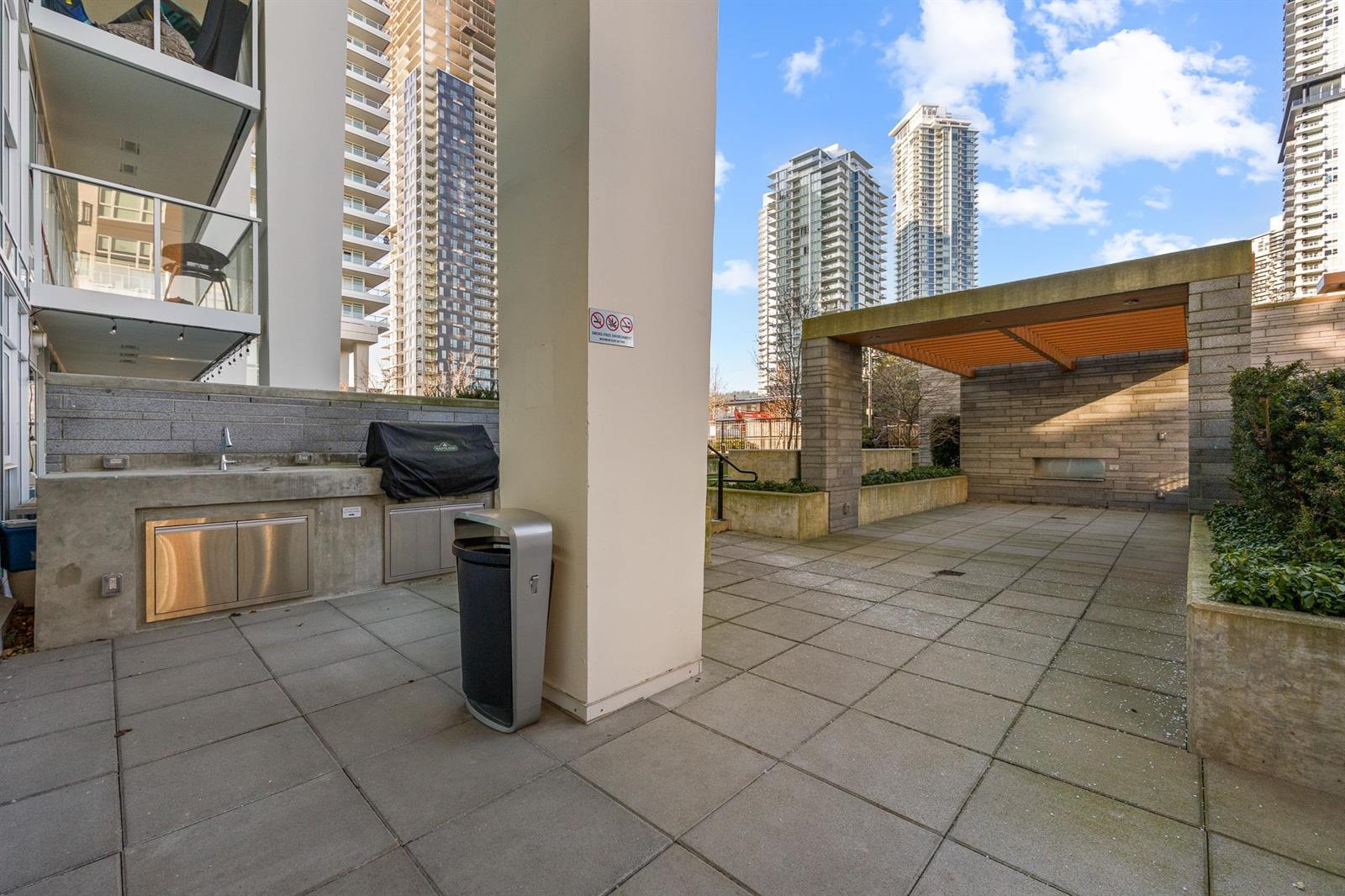 The outdoor kitchen, barbecues under cover beside the terrace.