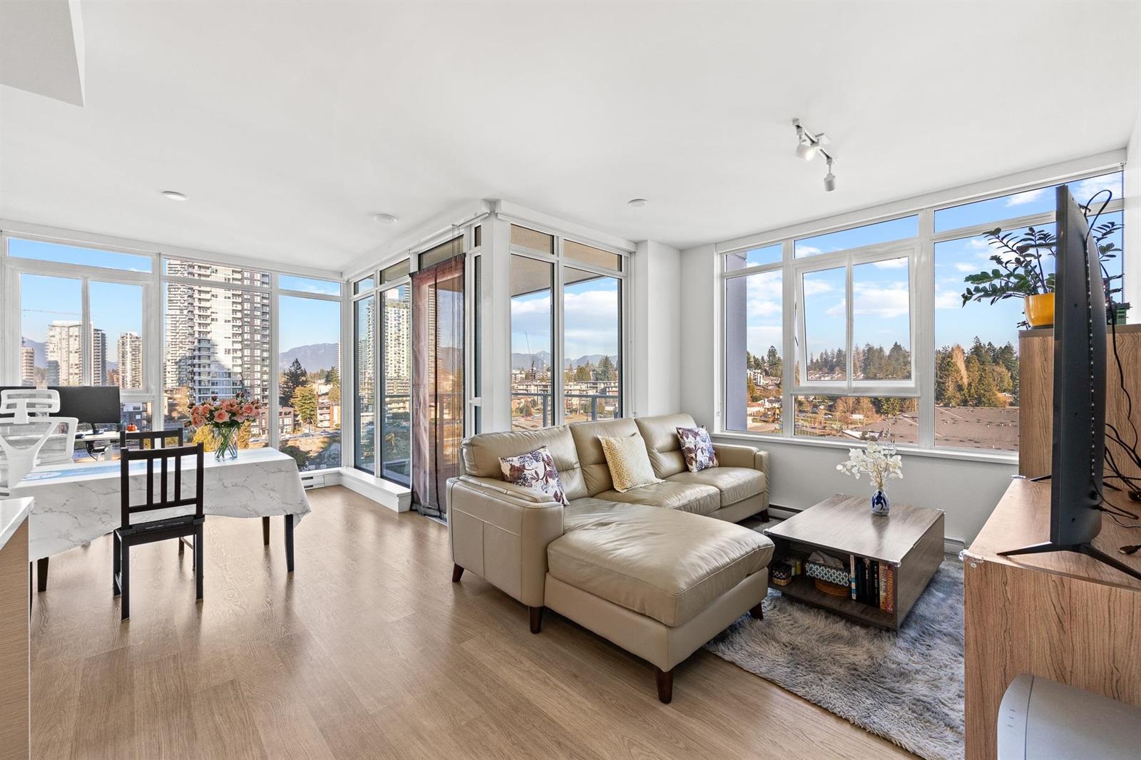 The living room in the corner, windows on two sides and the neighbourhood below.