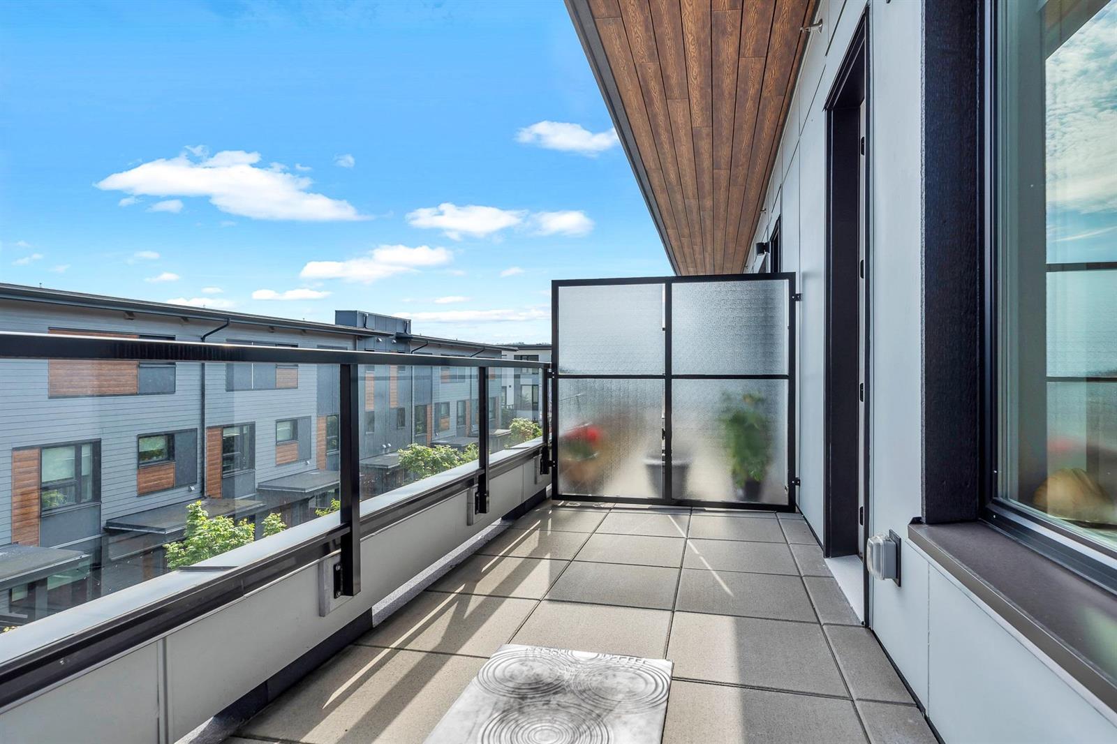 The upper balcony, looking out along the roofs of the terrace to the trees.