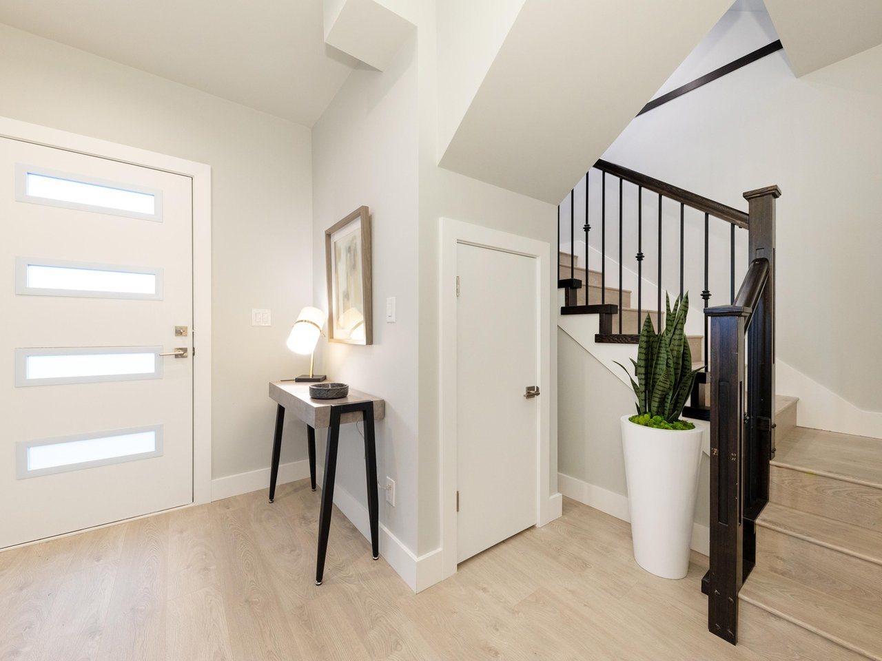 The entry hall inside the front door, the staircase turning up at the end.