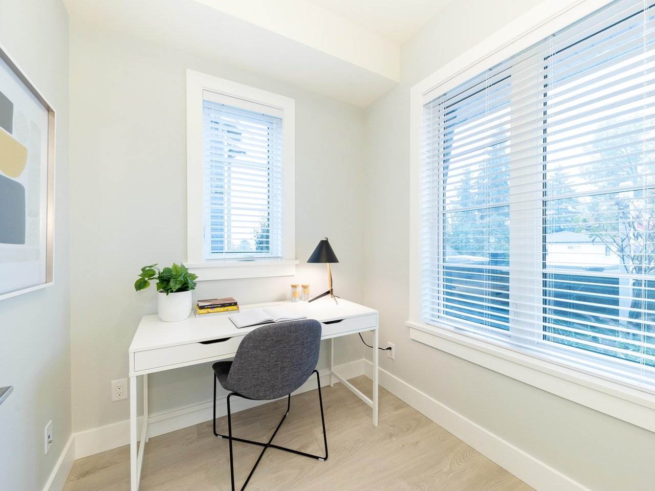 The den, a desk under a wide window with blinds drawn halfway.
