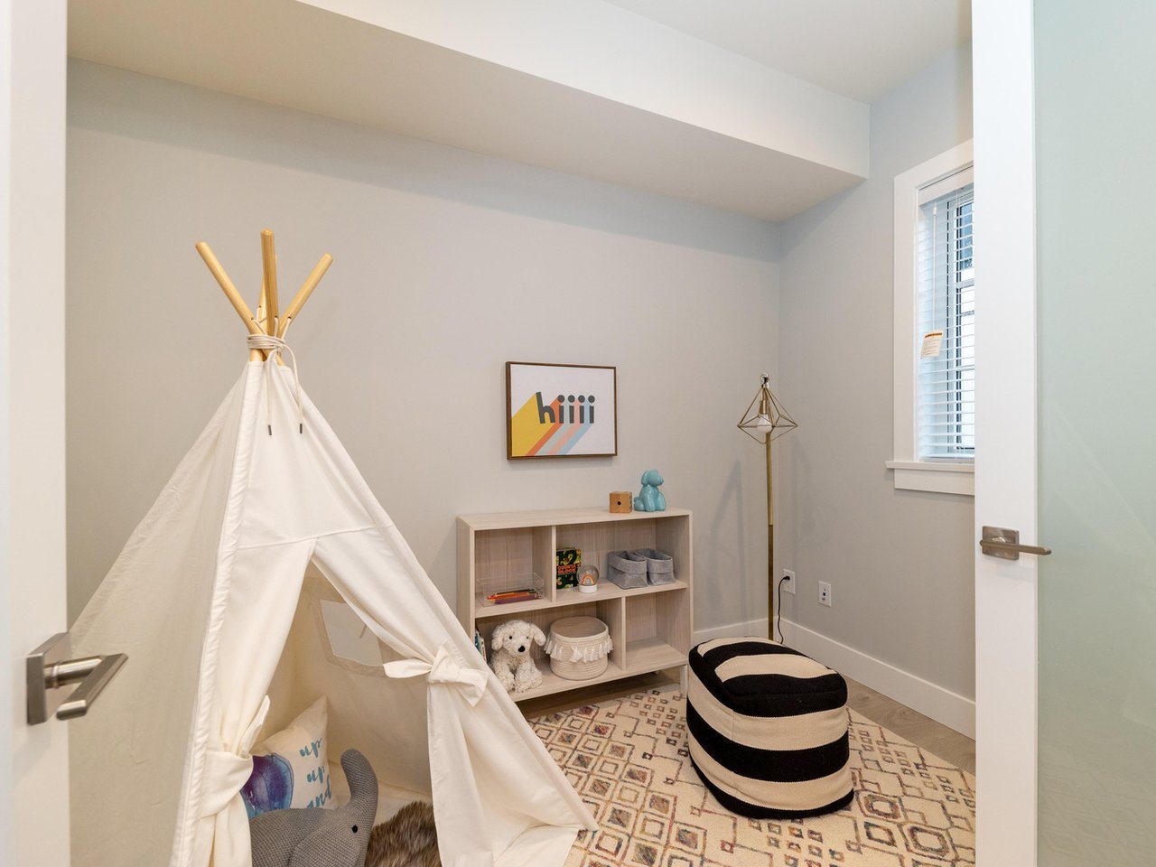 The fourth bedroom on the main floor, set up as a child's room with a play tent.