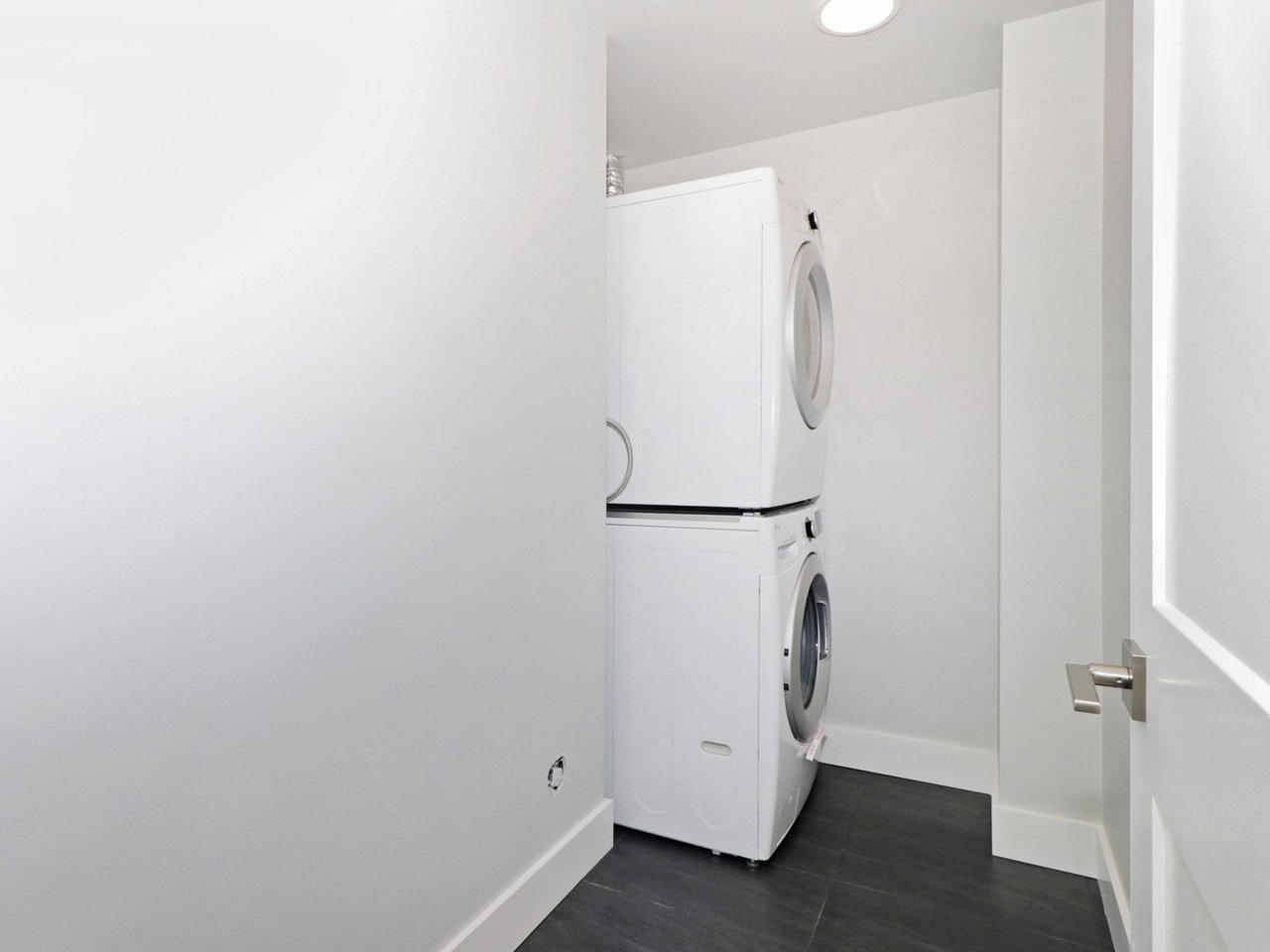 The laundry, a stacked washer and dryer in their own closet.