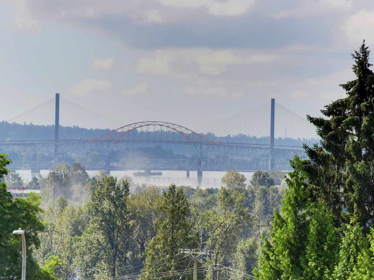 The view from the upper floor, out over the trees to the bridge and the river.