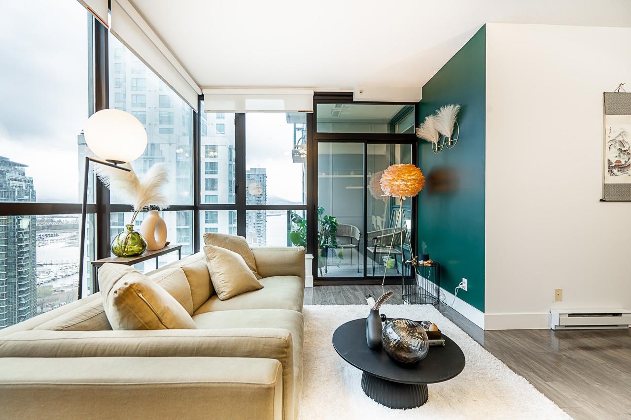 The living room from the entry, the balcony glass on the left and the seating group in the middle of the floor.