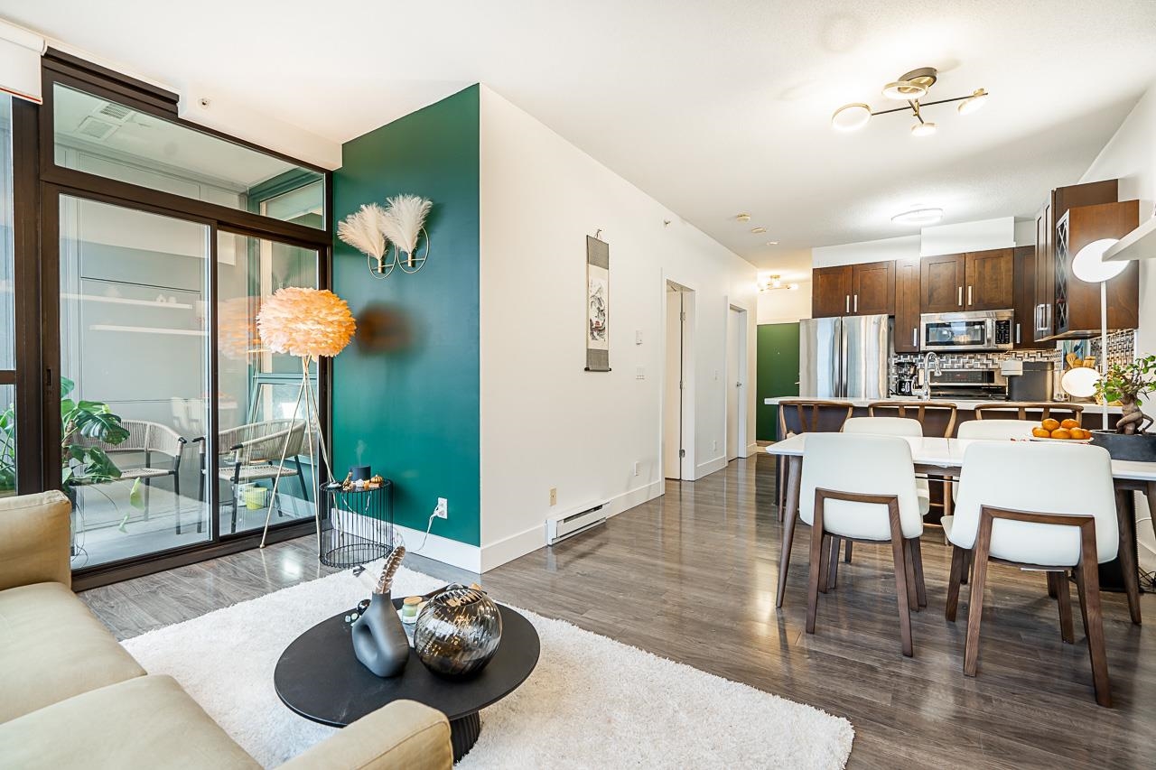 Looking down the length of the home from the living room, through the dining area to the kitchen.