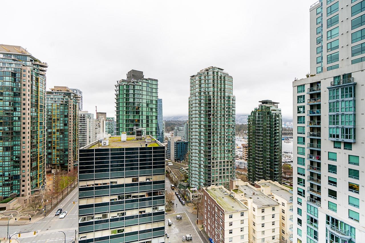 The outlook north over the rooftops of Coal Harbour toward the towers and the mountains.