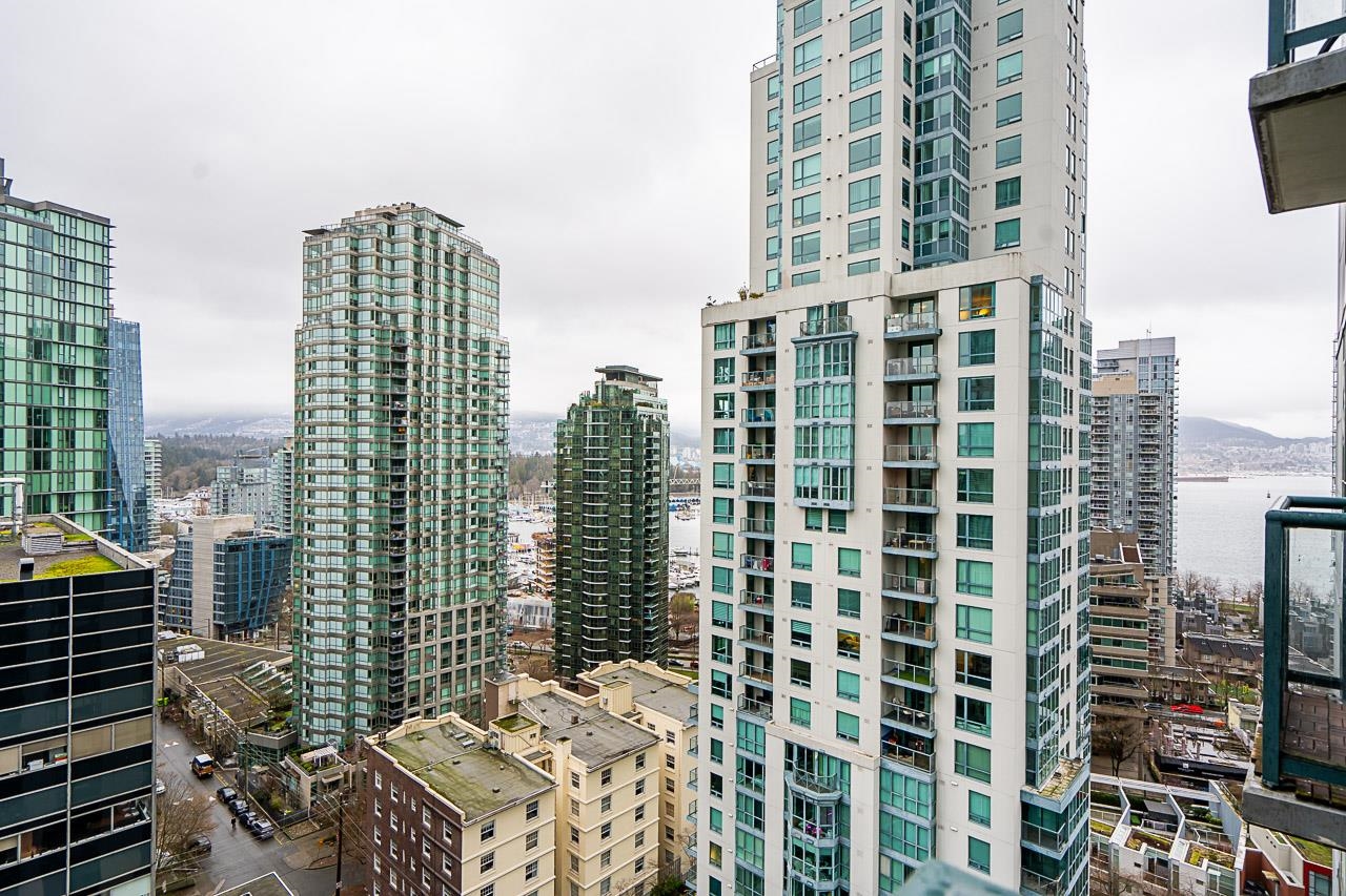 The view along the glass towers of Coal Harbour with the water showing between them.