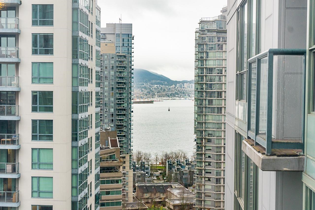 The view toward the harbour, the water and the far shore visible between the buildings.