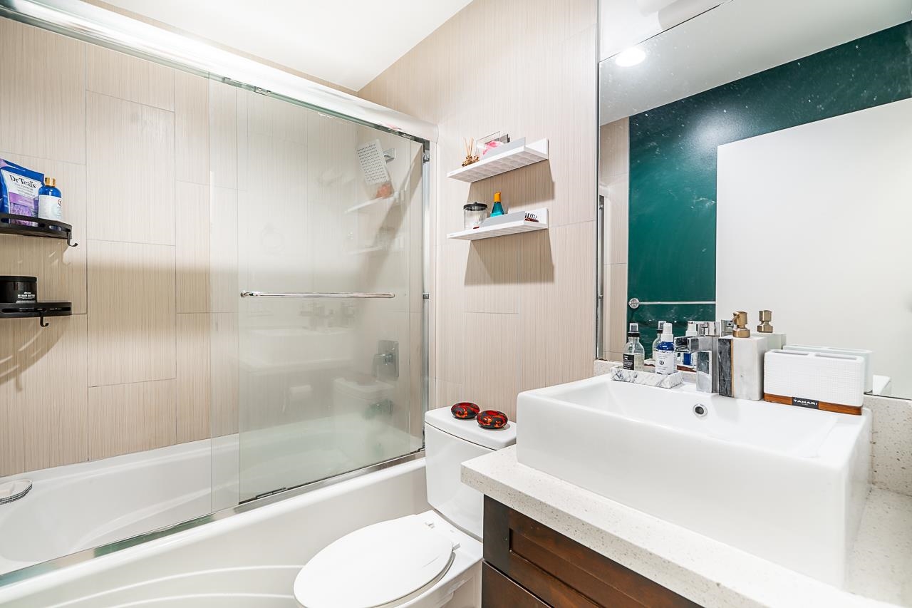 The bathroom, a soaking tub beside the counter with shelves above.