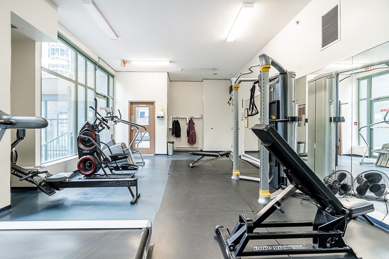 The gym, cardio machines and a weight station under the windows.