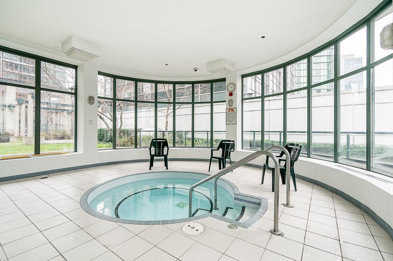 The hot tub in its round glazed room beside the pool.