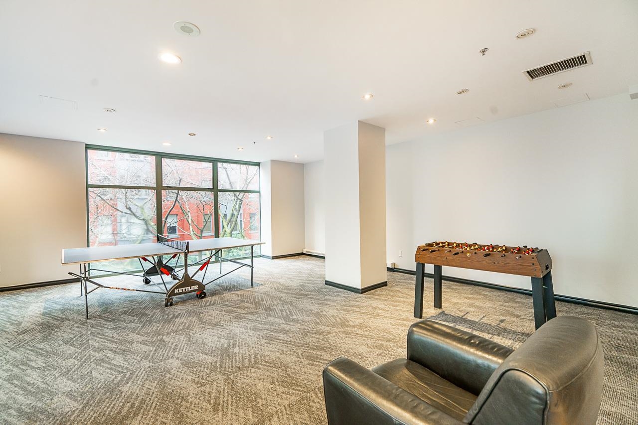 The party room itself, seating and a games table beside the windows.