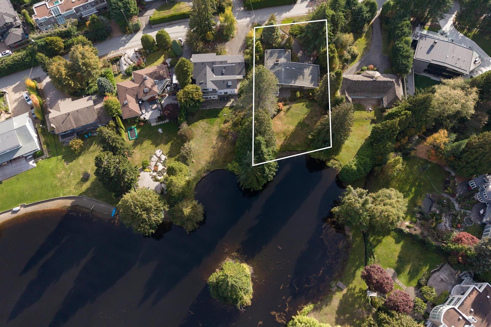 An aerial view of the property with the lot boundary drawn in, the lake below it.