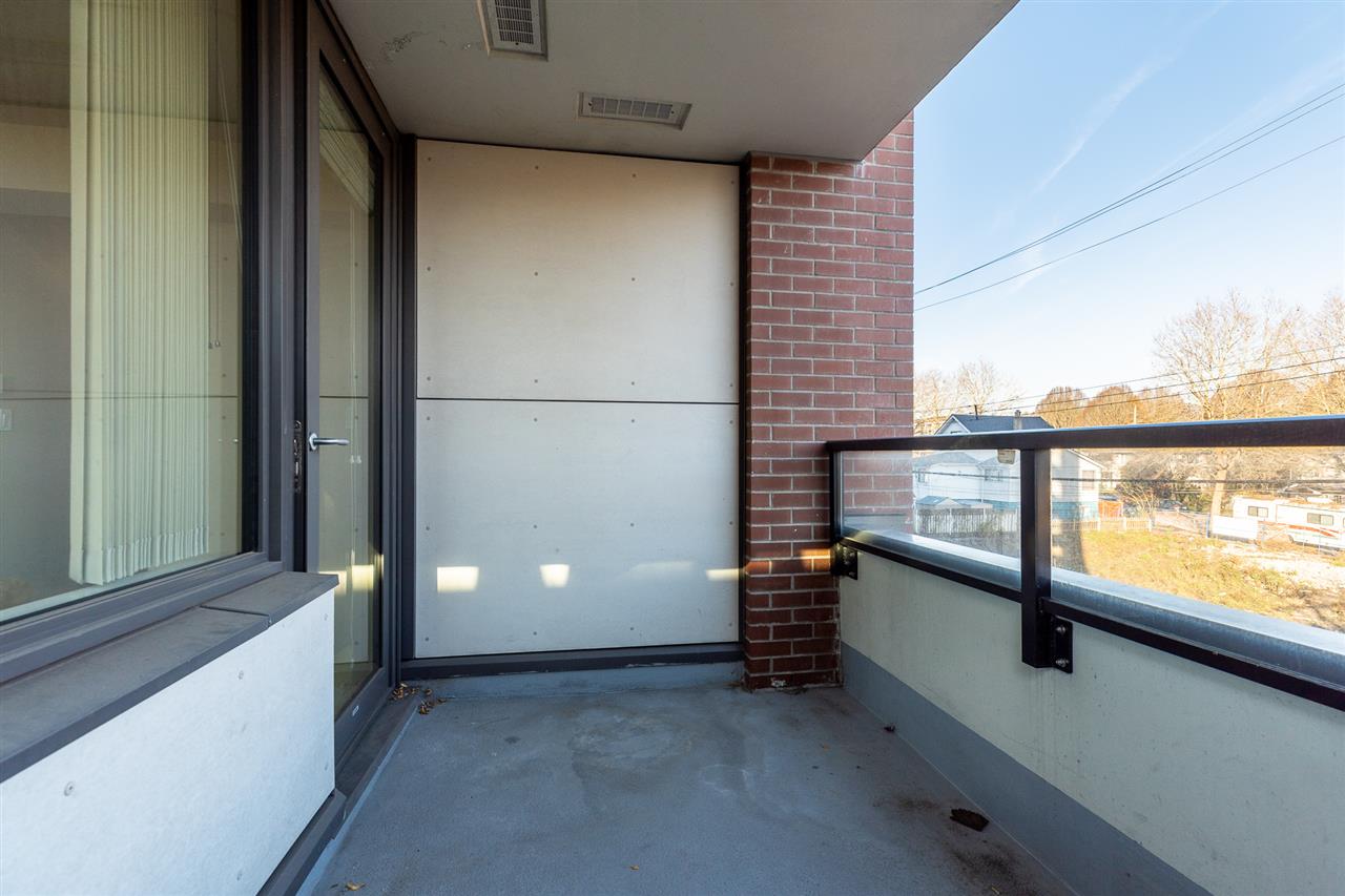 The covered balcony off the living room, screened on one side.