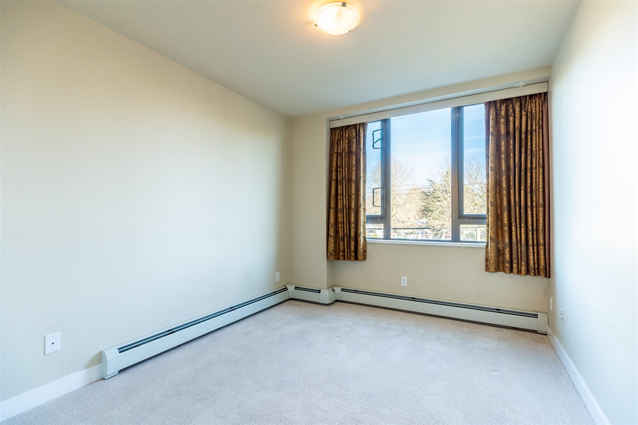 The primary bedroom, a window looking out over the neighbourhood.