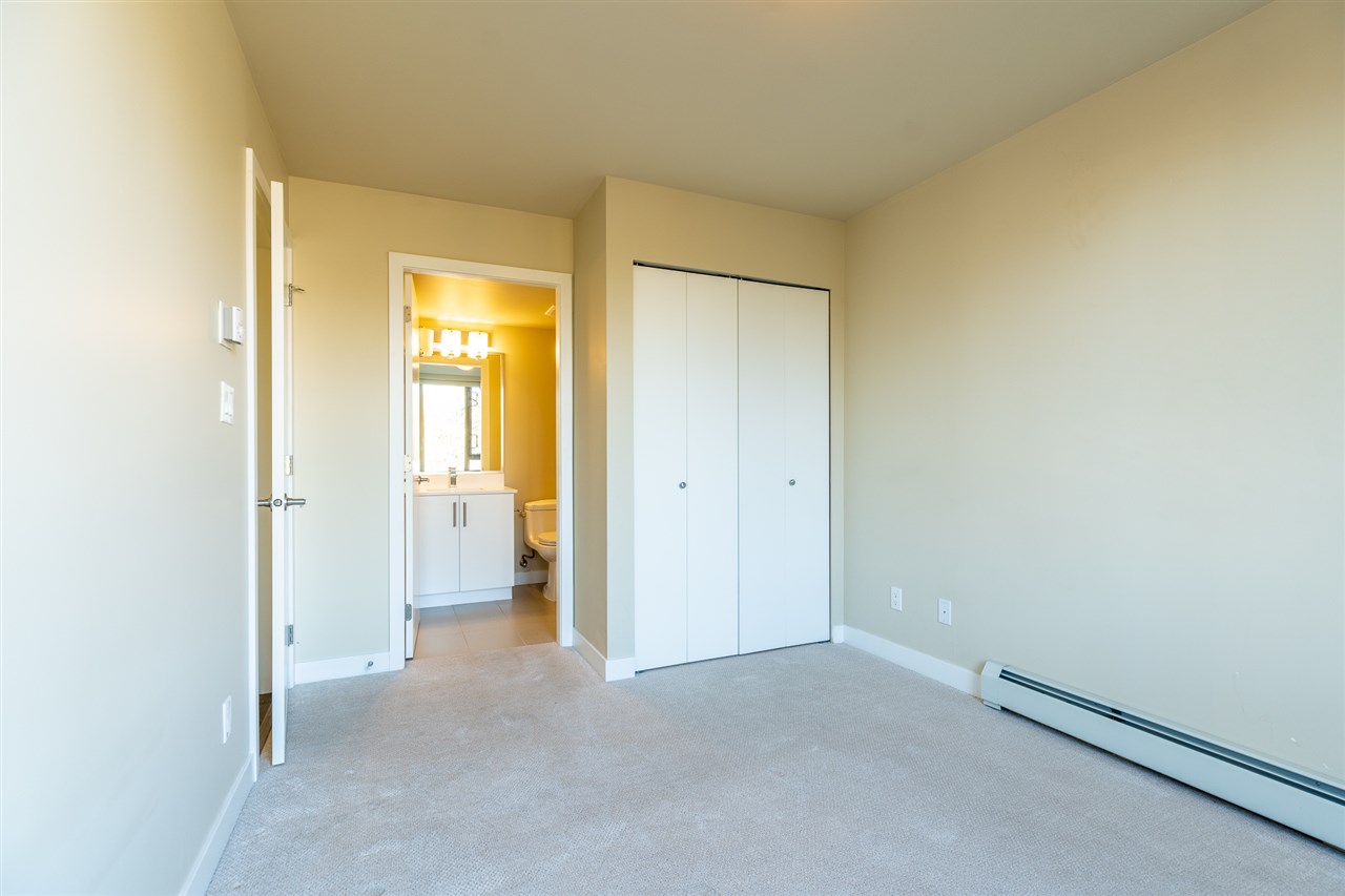 The primary bedroom from the doorway, the ensuite through the far door.