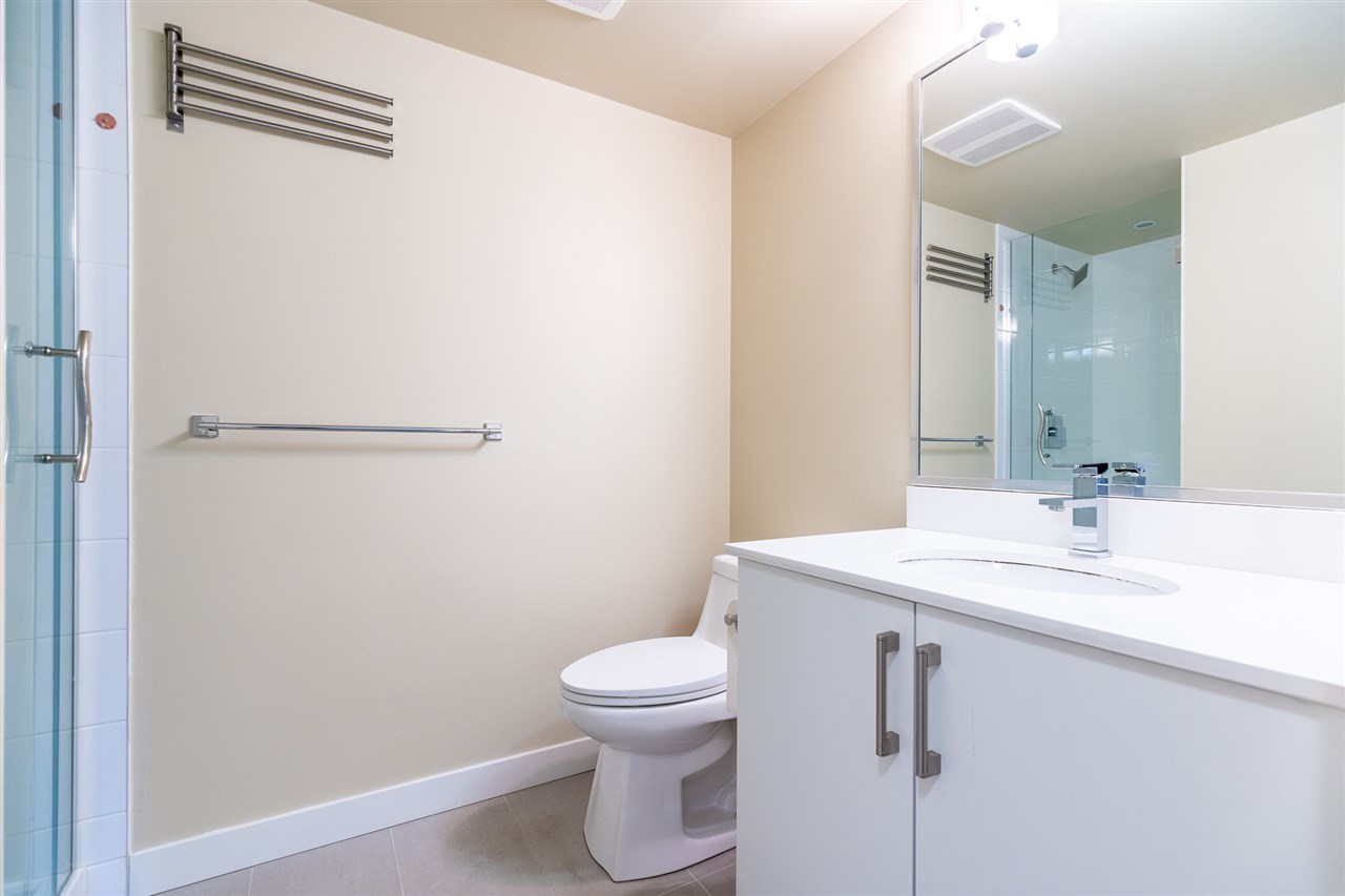 The main bathroom, a glass shower beside the vanity.