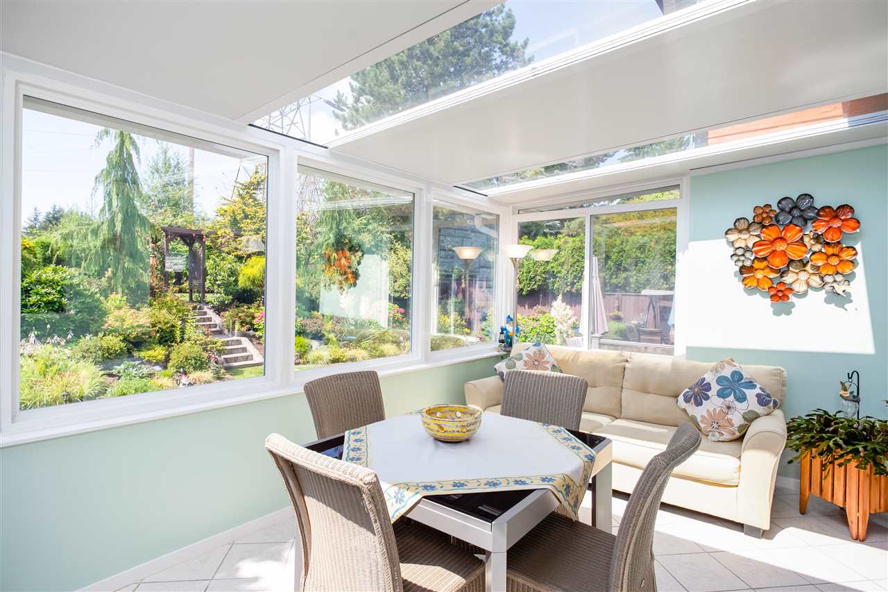 The eating room, glass on three sides with the table and chairs among the trees.