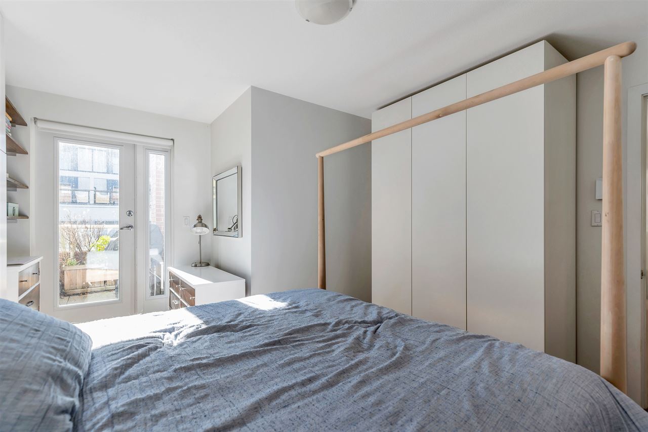 The primary bedroom looking to its patio door.