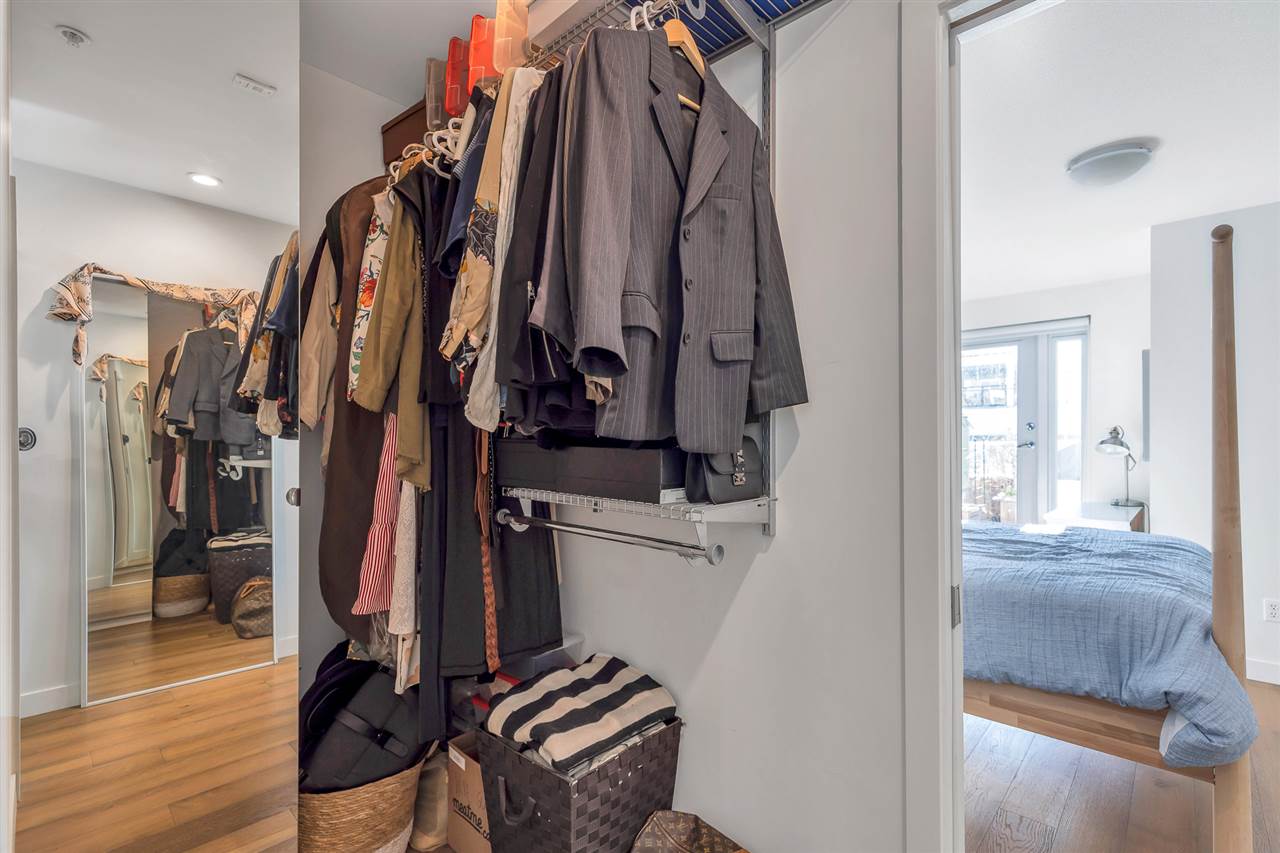 The walk-in closet off the primary bedroom, hanging rails on both sides.