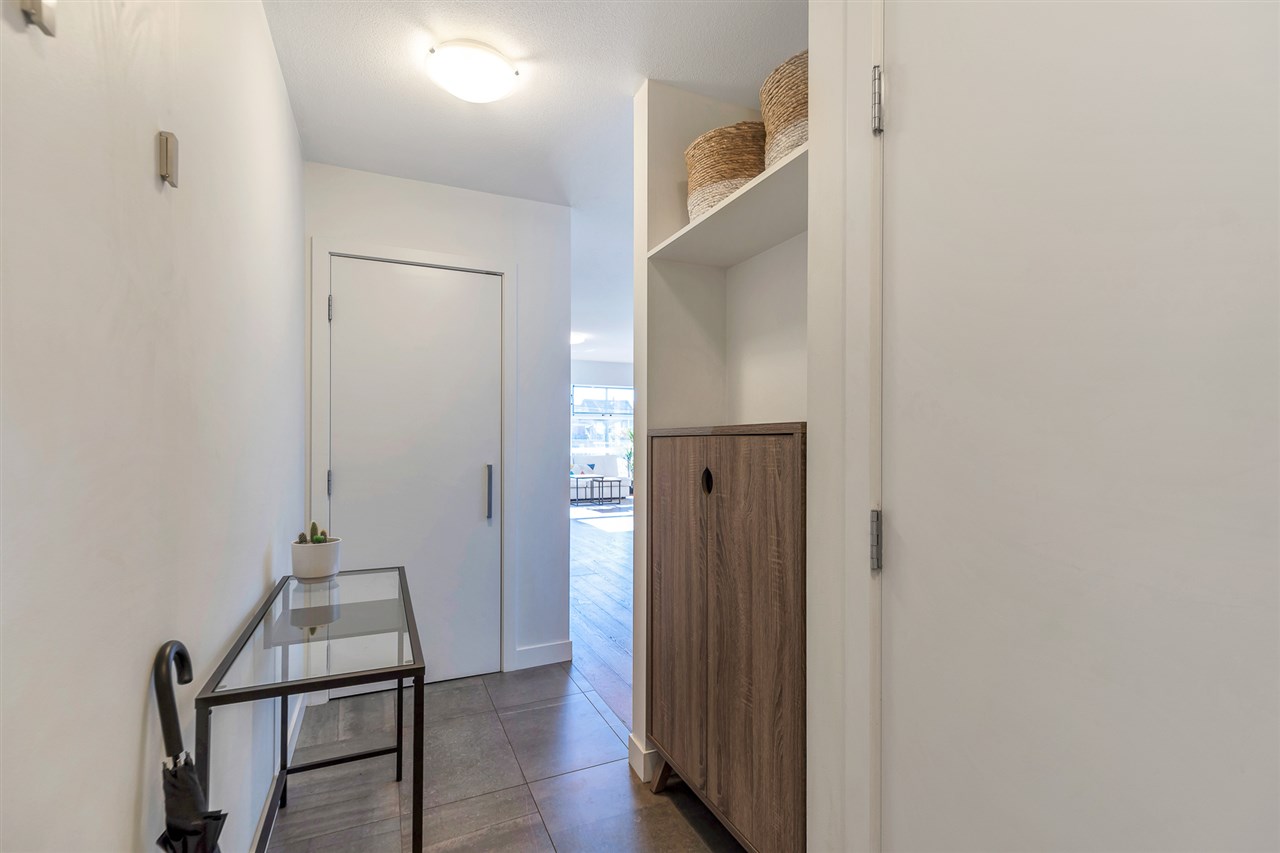 The entry hall, the storage cupboard open on one side.