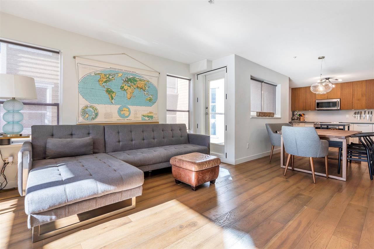 The living room and the dining room together, hardwood running the length of the home.