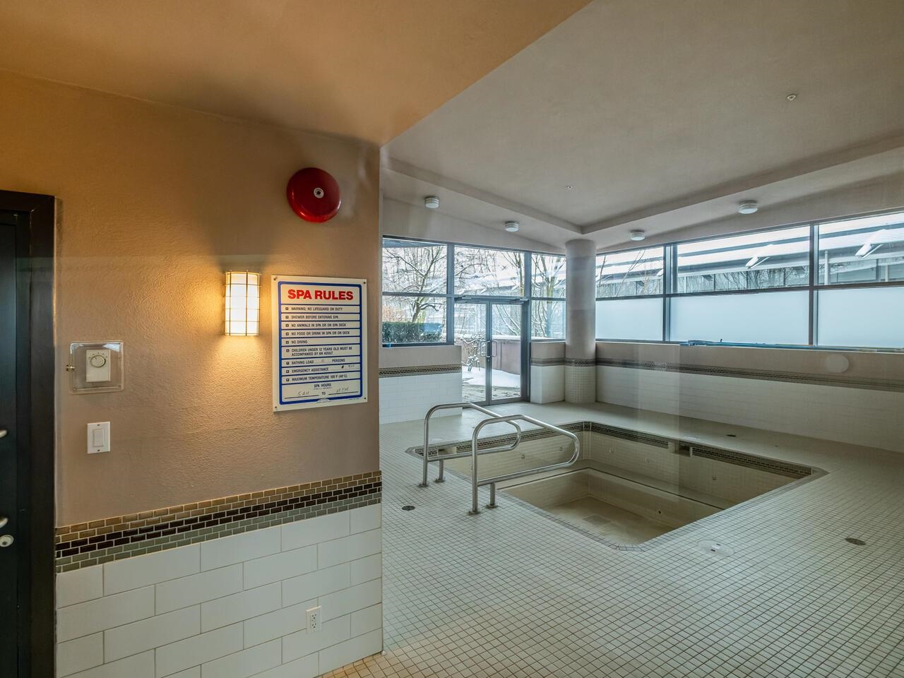 The hot tub, sunk into tile in a glazed room off the amenity building.