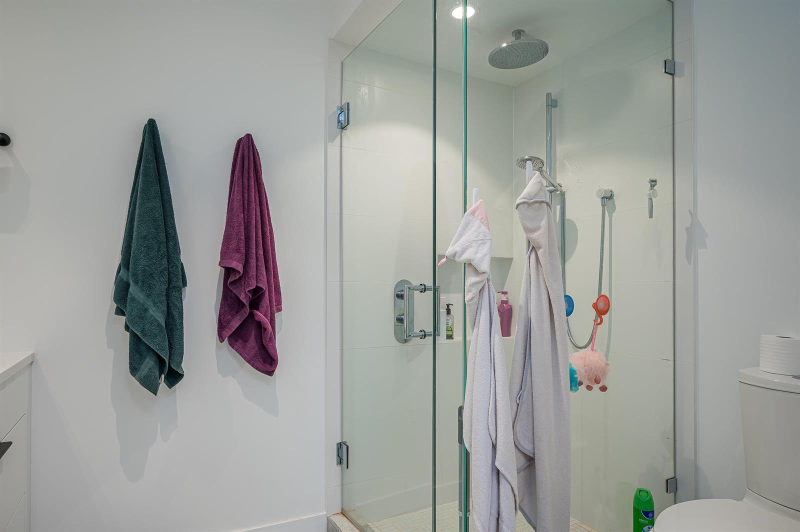 The shower, glazed on two sides, with a rainfall head.