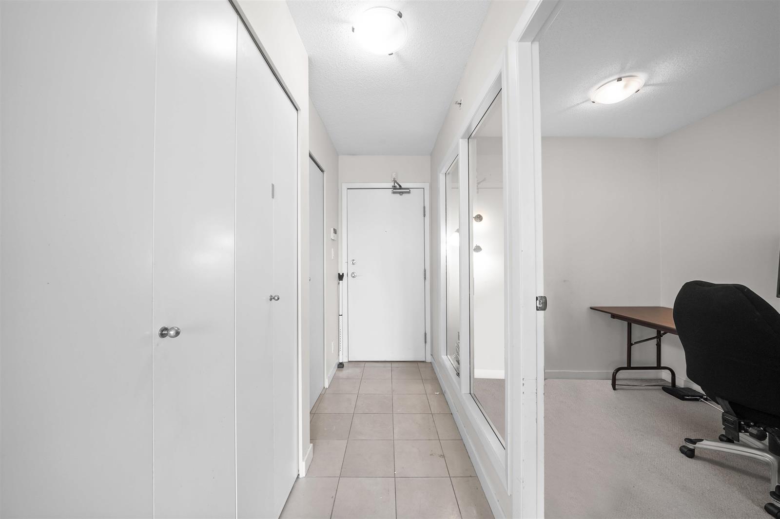 The hall, doors along both sides and the entrance at the end.