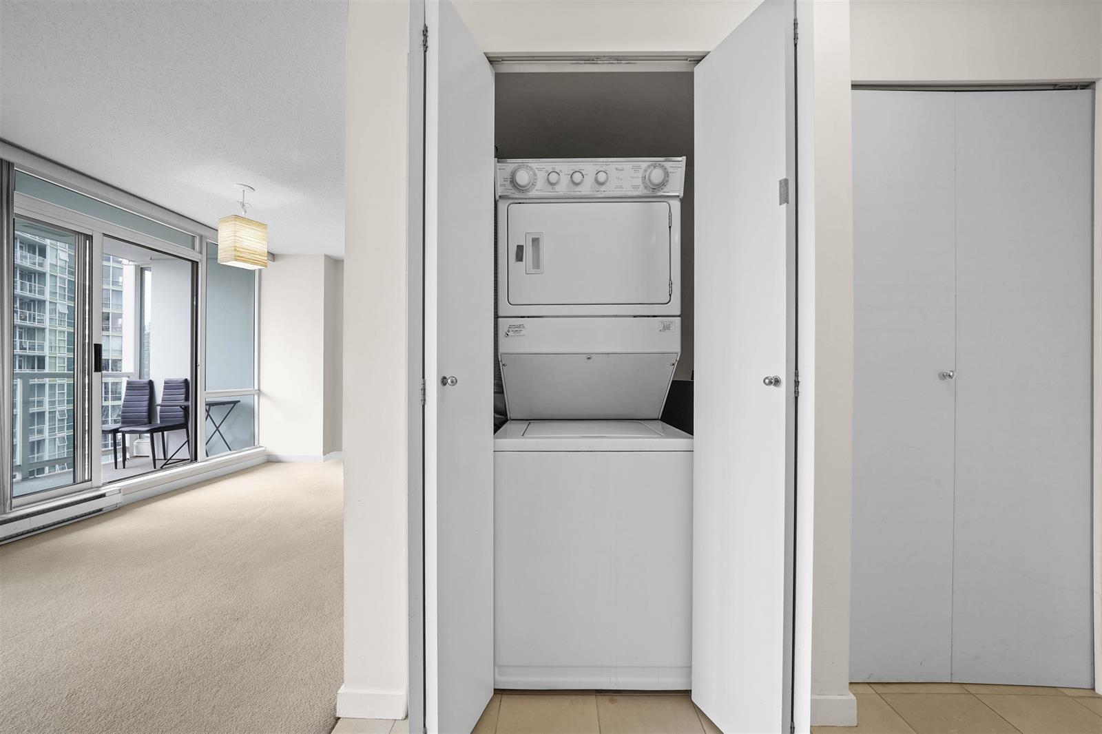 The laundry, a stacked washer and dryer in a closet off the hall.