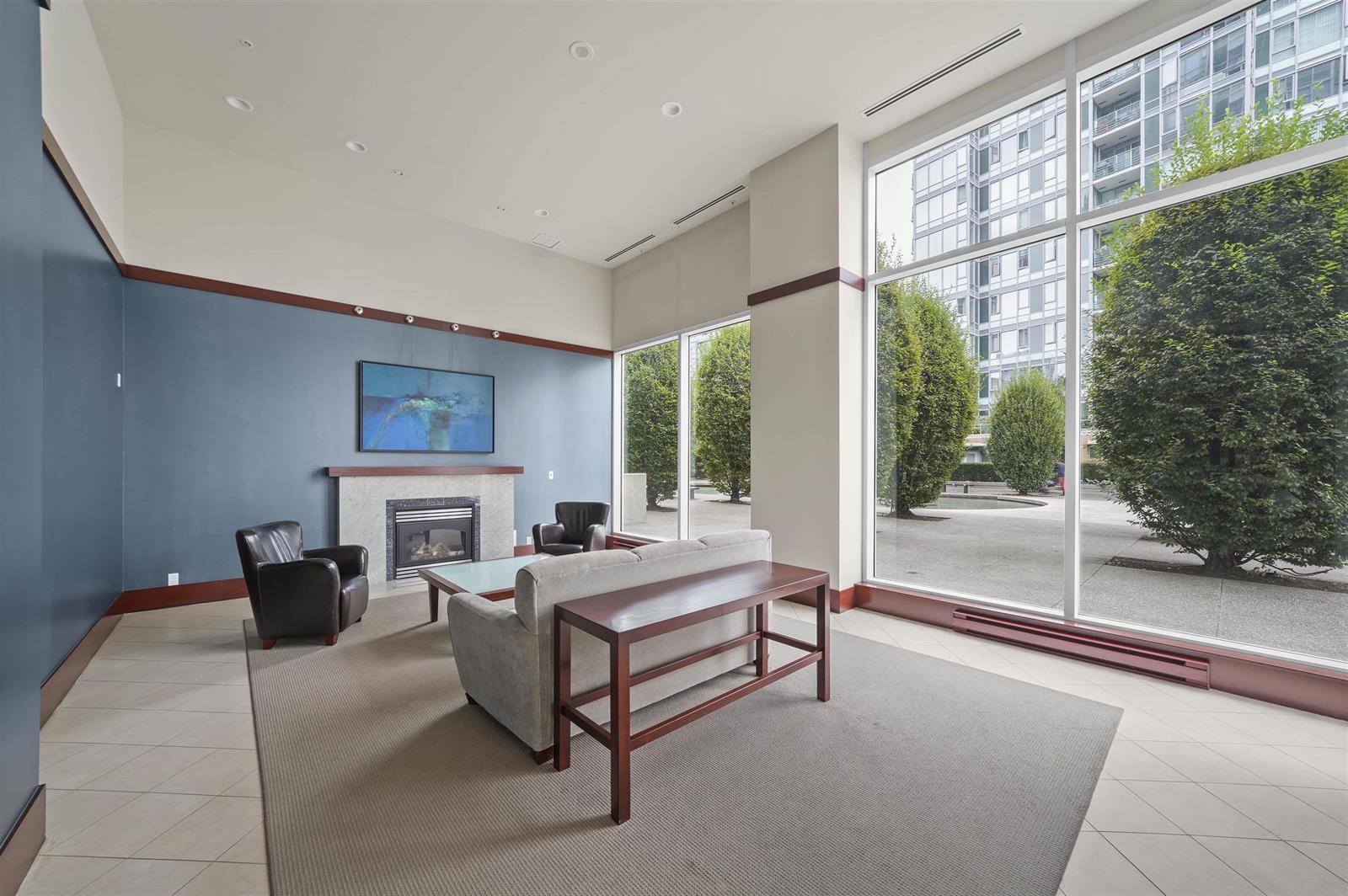 The lounge off the lobby, a fireplace and seating under tall windows onto the garden.
