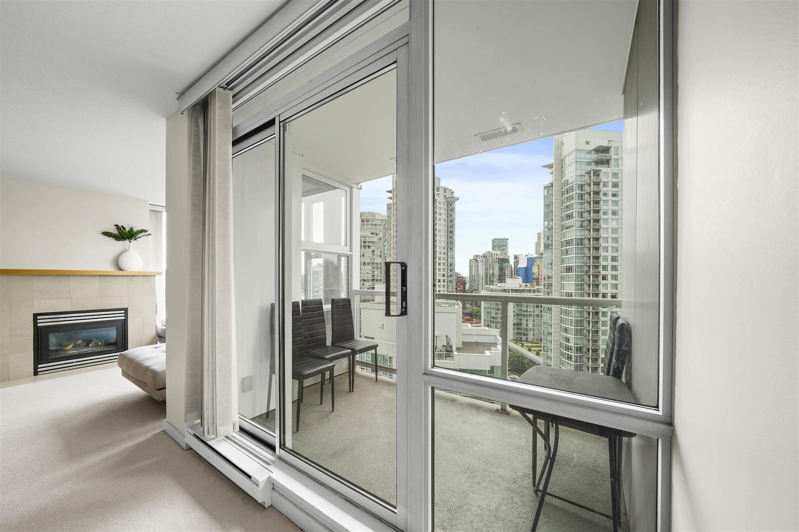 The corner by the balcony, the fireplace to one side and the sliding glass opening onto the deck.