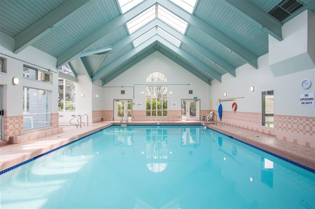 The indoor pool under a vaulted ceiling with skylights running along the ridge.