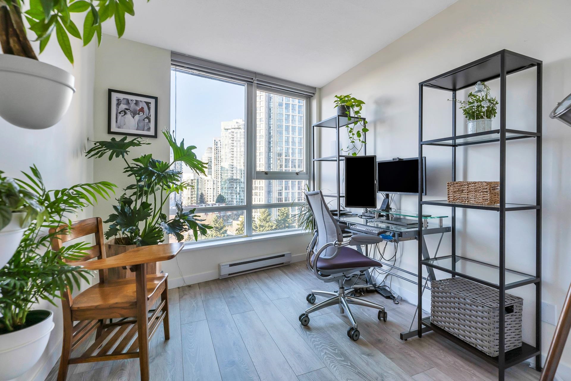 The office off the hall, a desk under the window with the Yaletown towers behind it.