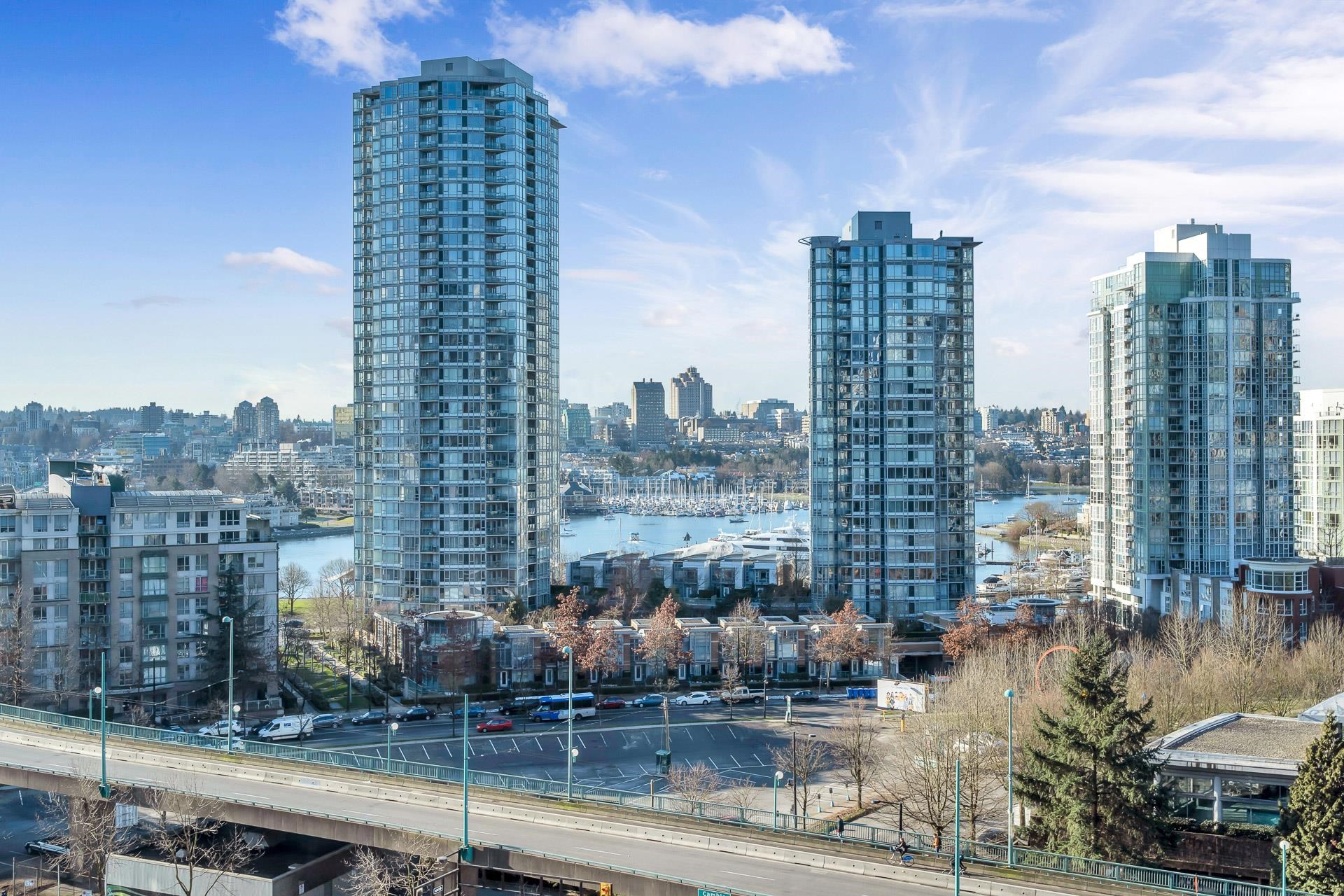 The view over False Creek — towers, the marina full of boats, and the low roofs beyond.