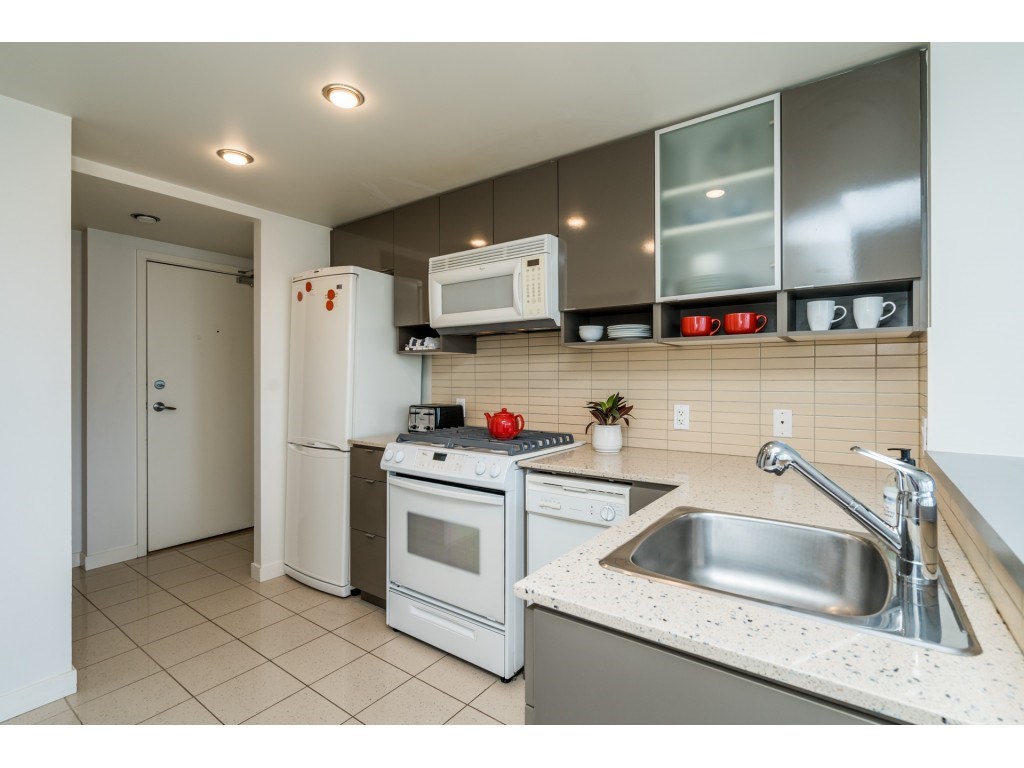 The kitchen sink under the window wall, the range and microwave along the near side.