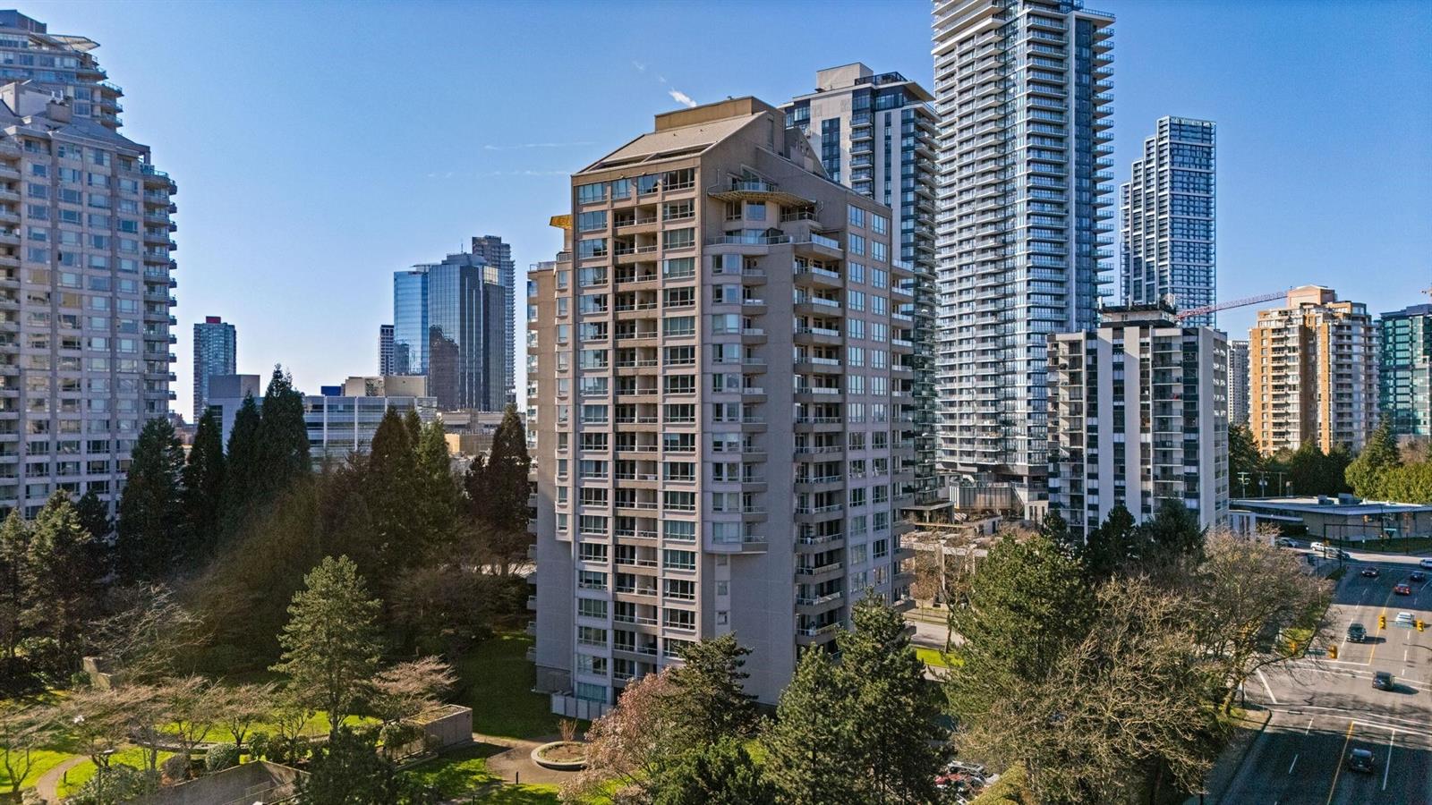 La Mirage from above, the tower rising among cedars with the towers of Metrotown behind it.