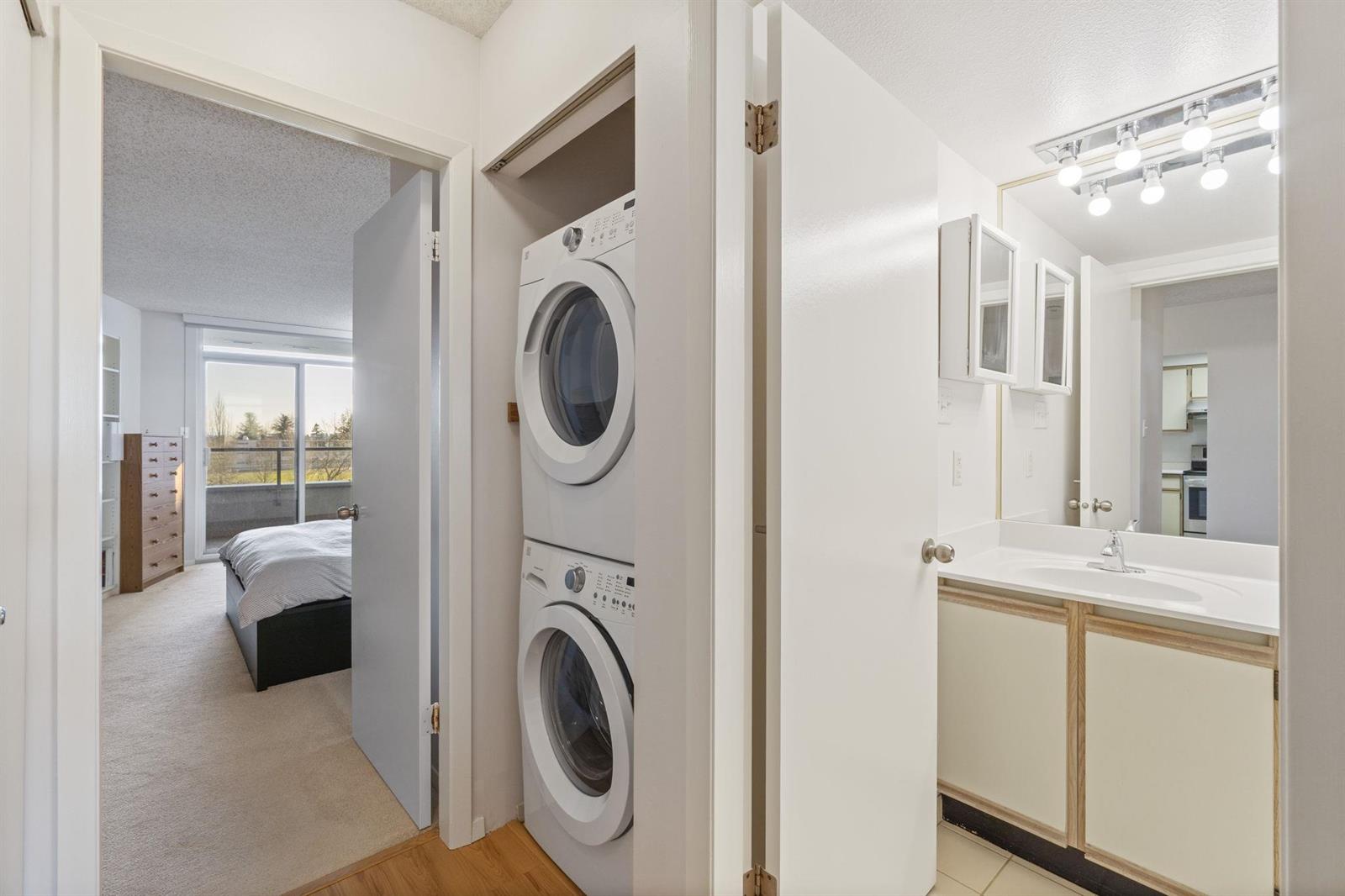The laundry, a stacked washer and dryer in a closet between the bedroom and the bathroom.