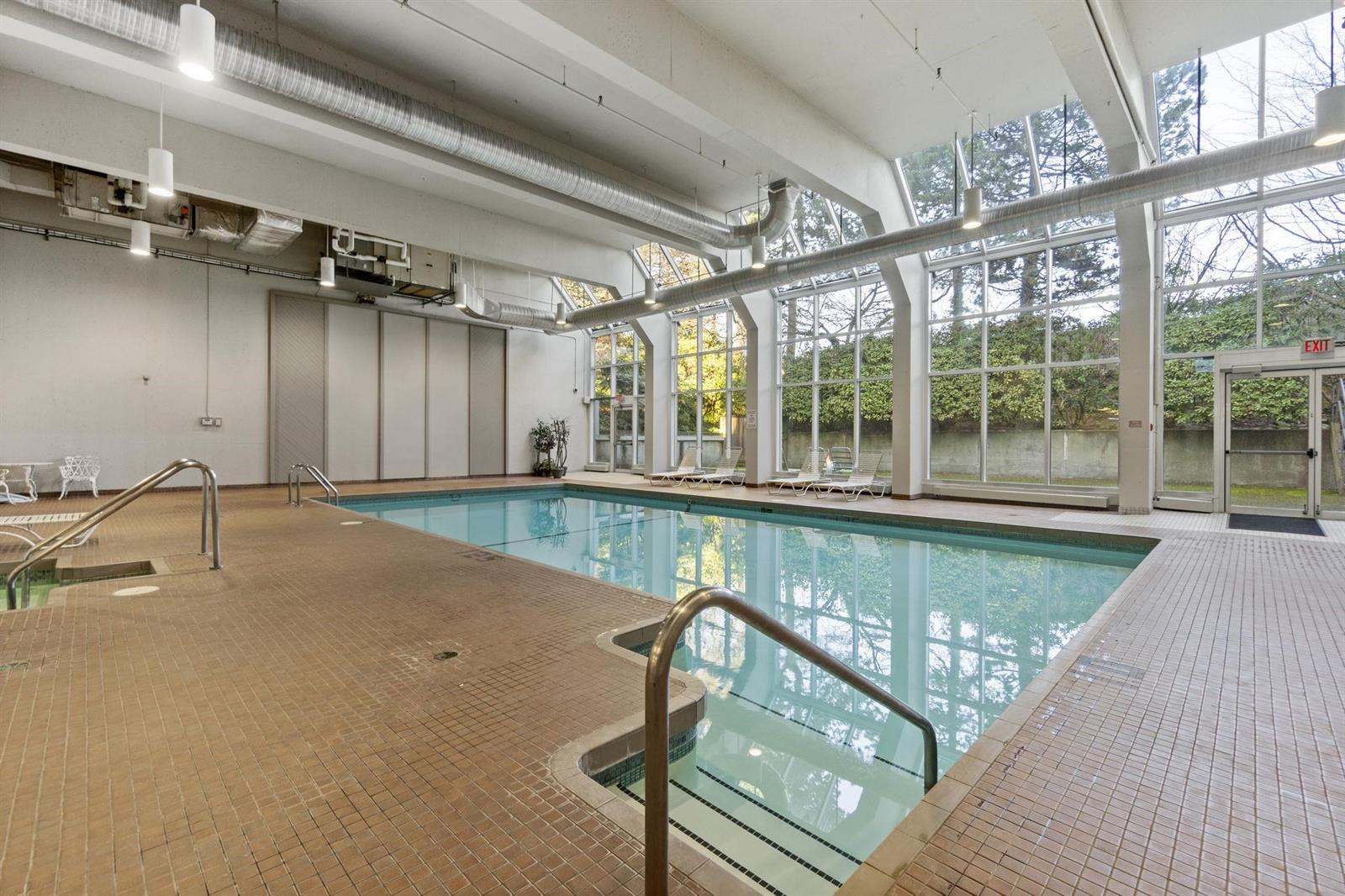 The indoor swimming pool, a glazed wall along one side looking onto the garden.