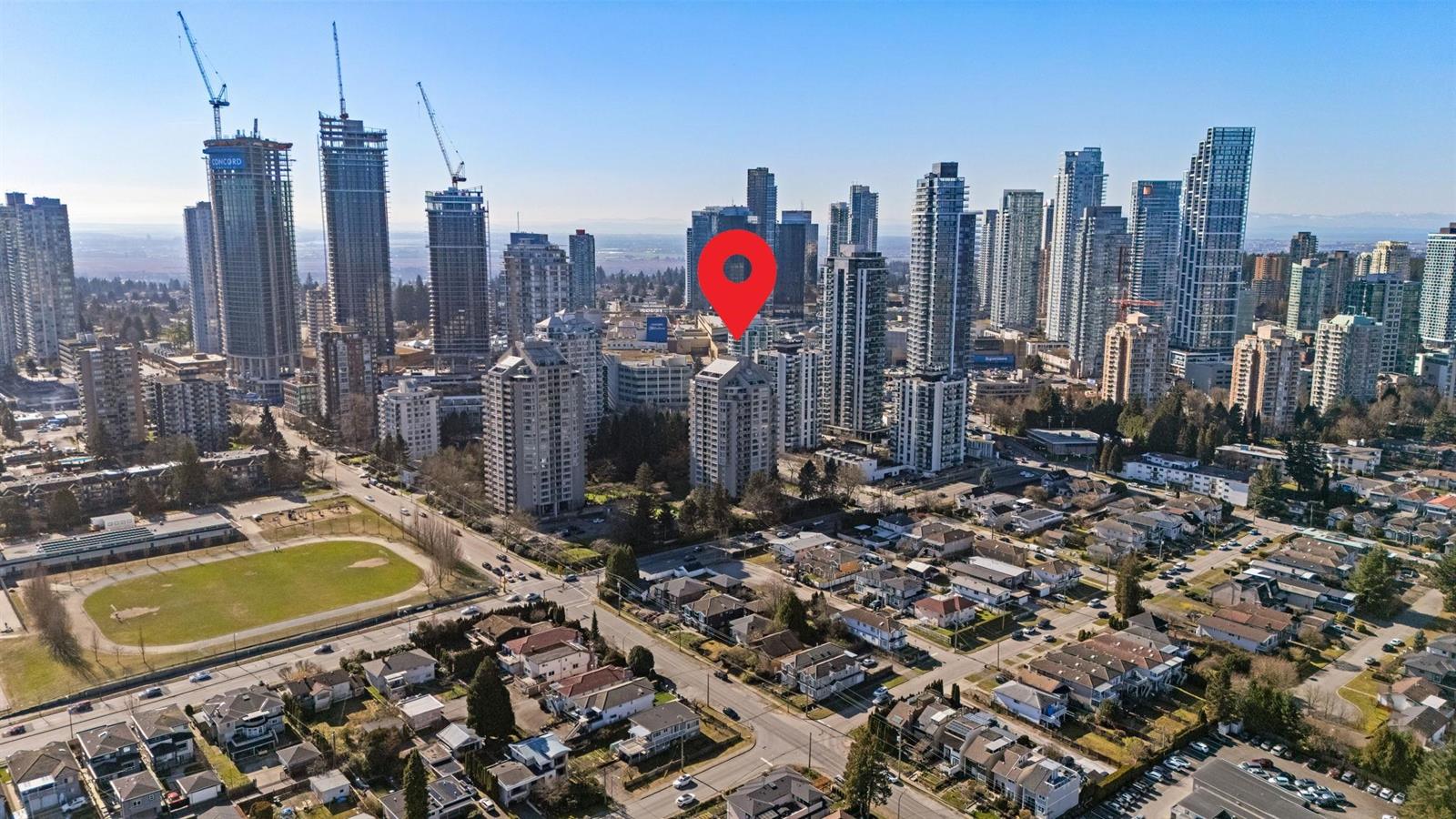 An aerial view across the neighbourhood, Central Park on the left and the Metrotown towers behind.