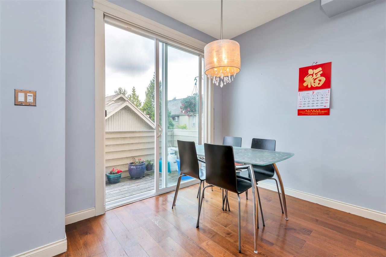 The eating area beside a sliding door out to the deck.