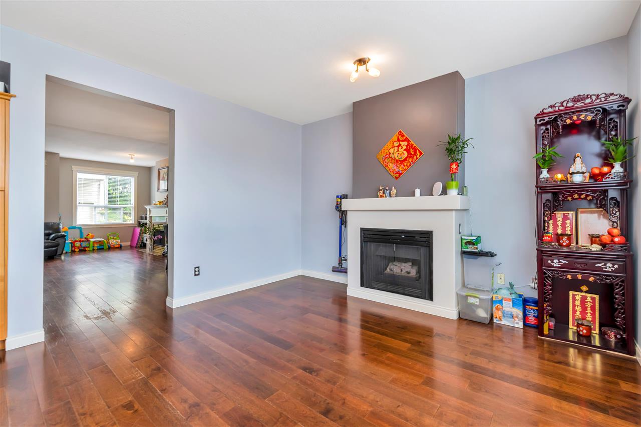 The family room with the second gas fireplace and a display cabinet beside it.
