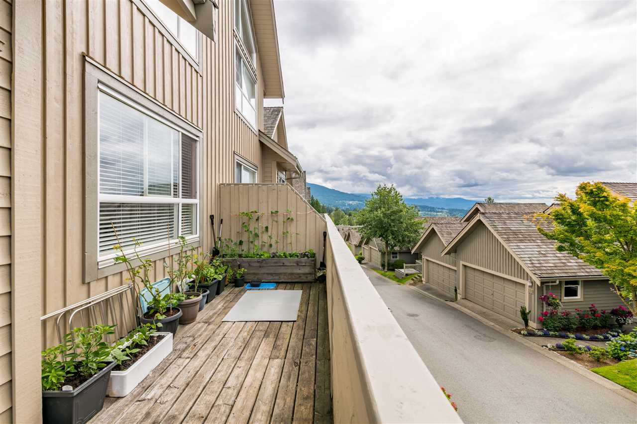 The side of the deck, planters along the rail and the mountains in the distance.