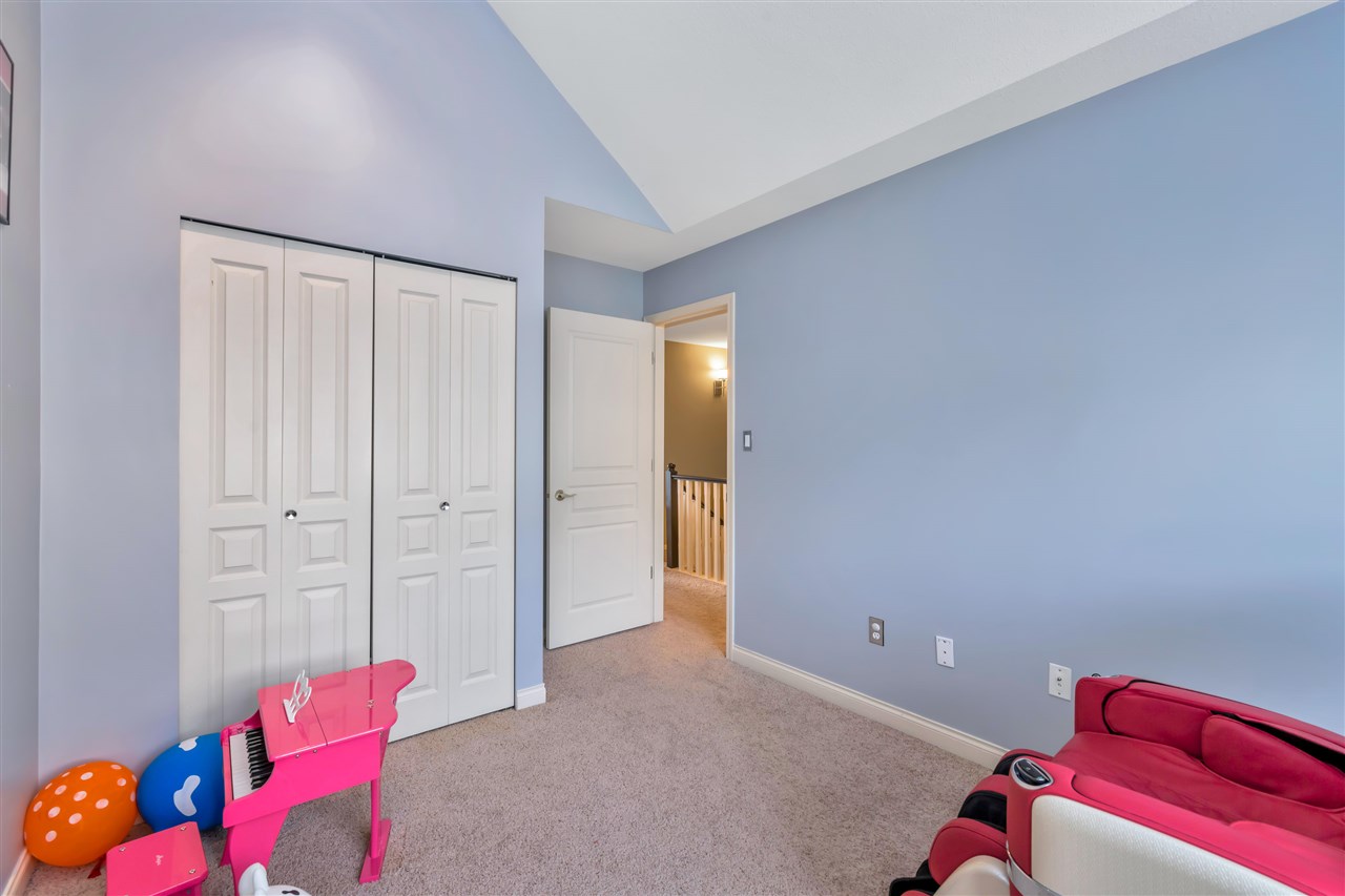 The same bedroom from the doorway, closets along one side.